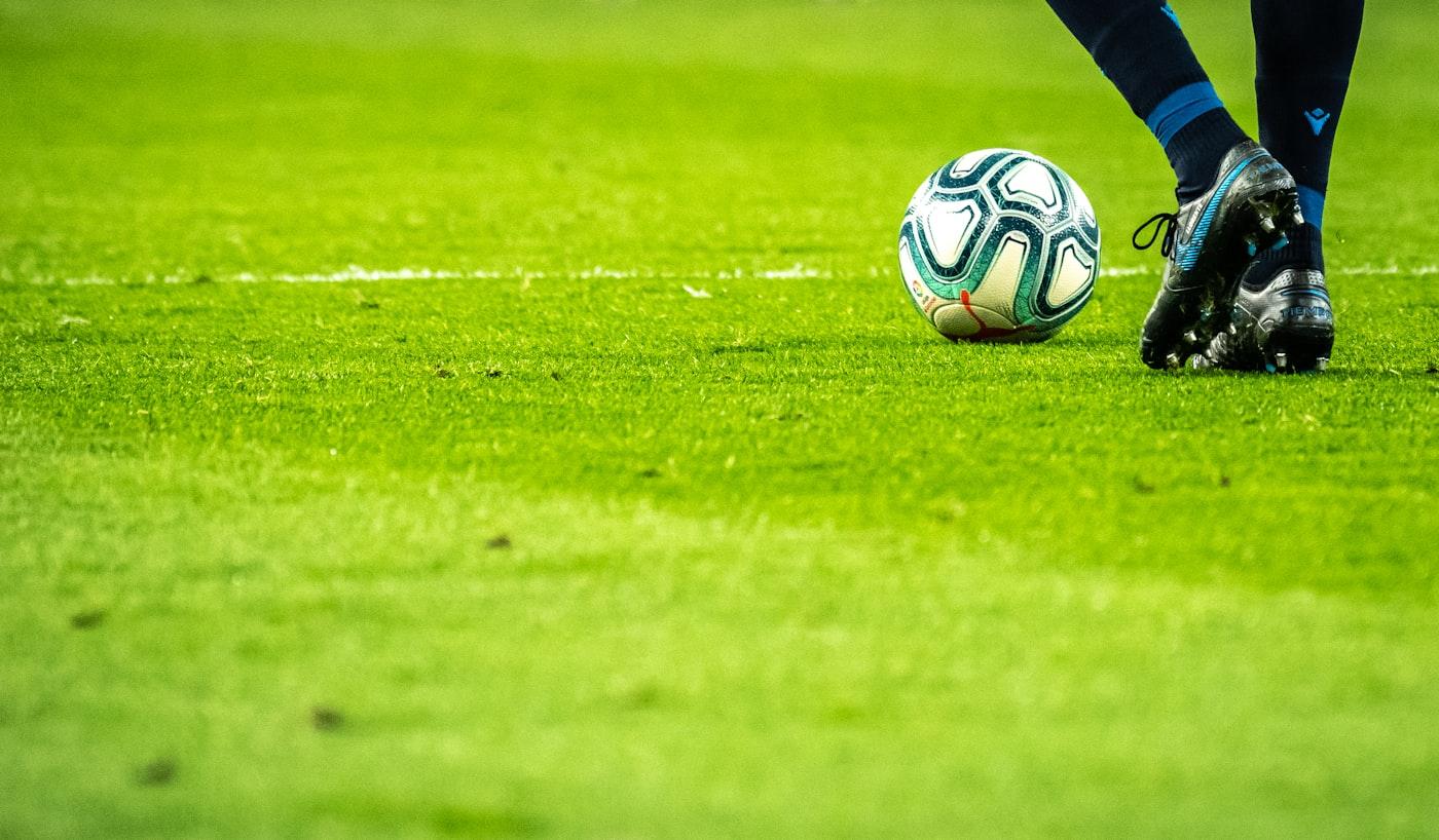 A soccer ball on a stadium pitch during a match